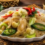 A bowl of authentic Indonesian Oseng-Oseng Kembang Kol dan Soun with oyster mushrooms